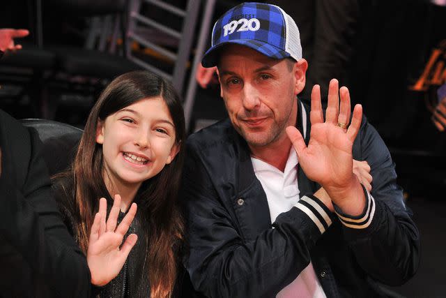 <p>Allen Berezovsky/Getty</p> Adam and Sunny Sandler at a Los Angeles Lakers game in 2018