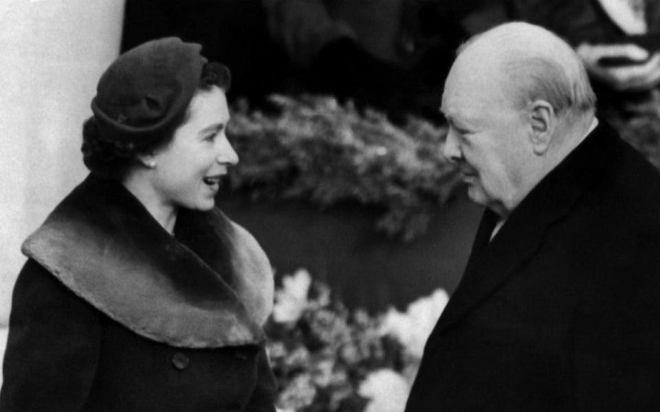 The Queen chats to Sir Winston Churchill whilst awaiting the arrival of the late Queen Elizabeth the Queen Mother at London’s Waterloo station in 1954 - TopFoto