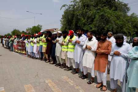 Supporters of the Jamaat-ud-Dawa Islamic organization offer funeral prayers in absentia for the victims of Friday's suicide attack at an election rally in Mastung, outside a mosque in Islamabad, Pakistan July 14, 2018. REUTERS/Faisal Mahmood