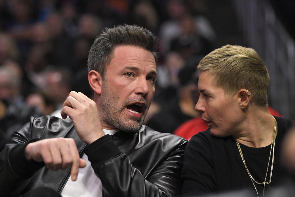 Actor Ben Affleck, left, watches during the first half of an NBA basketball game between the Los Angeles Clippers and the Philadelphia 76ers Sunday, March 1, 2020, in Los Angeles. (AP Photo/Mark J. Terrill)