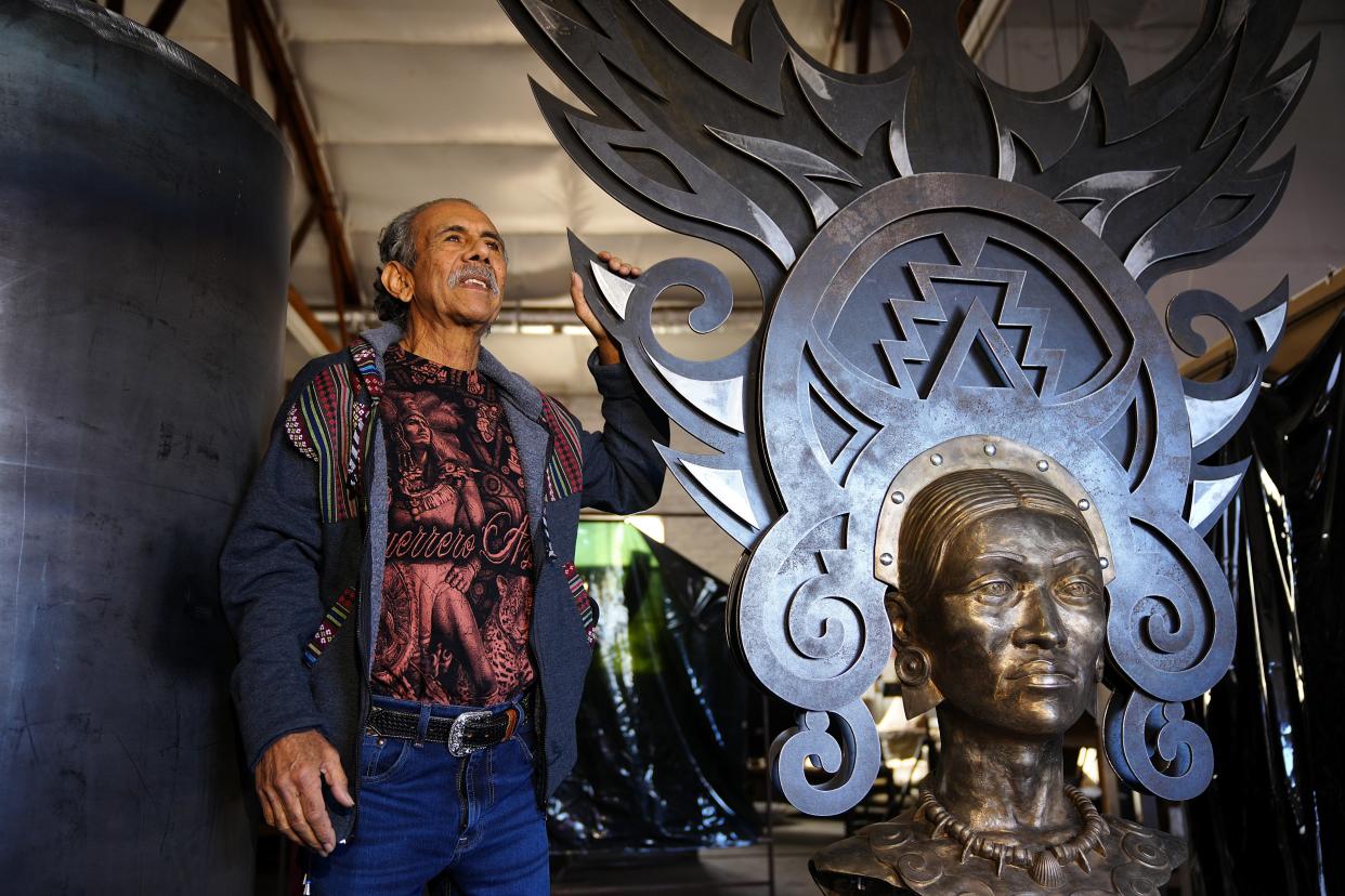 Zarco Guerrero stands with the bust of his sculpture in progress to be set at the light rail at the Baseline Road station on Jan. 11, 2022, in Mesa.
