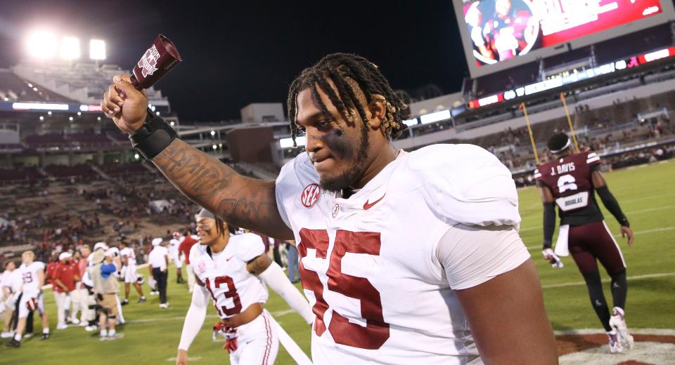 Sep 30, 2023; Starkville, Mississippi, USA; Alabama Crimson Tide offensive lineman JC Latham (65) celebrates with a cow bell in Davis Wade Stadium at Mississippi State University. Alabama defeated Mississippi State 40-17. Mandatory Credit: Gary Cosby Jr.-Tuscaloosa News