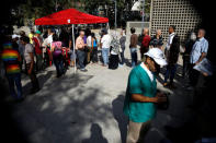 FILE PHOTO: Venezuelan citizens wait to check in at a "Red Point," an area set up by President Nicolas Maduro's party, to verify that they cast their votes during the presidential election in Caracas, Venezuela, May 20, 2018. REUTERS/Carlos Garcia Rawlins/File Photo