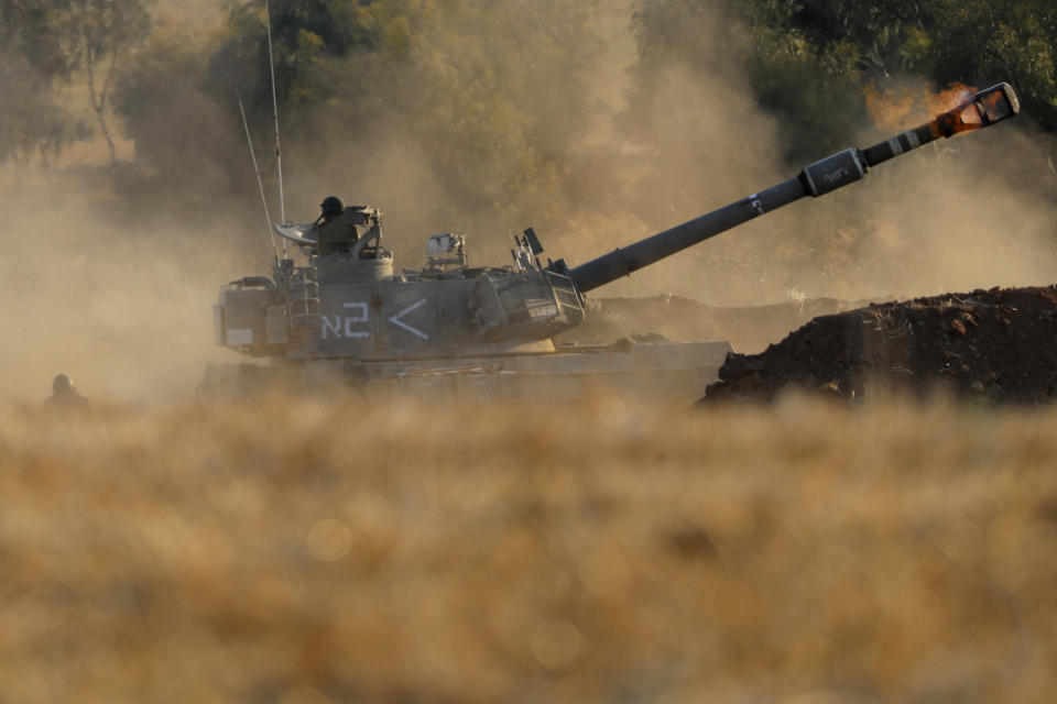 An Israeli artillery unit fires toward targets in Gaza Strip, at the Israeli Gaza border, Thursday, May 13, 2021. (AP Photo/Ariel Schalit)