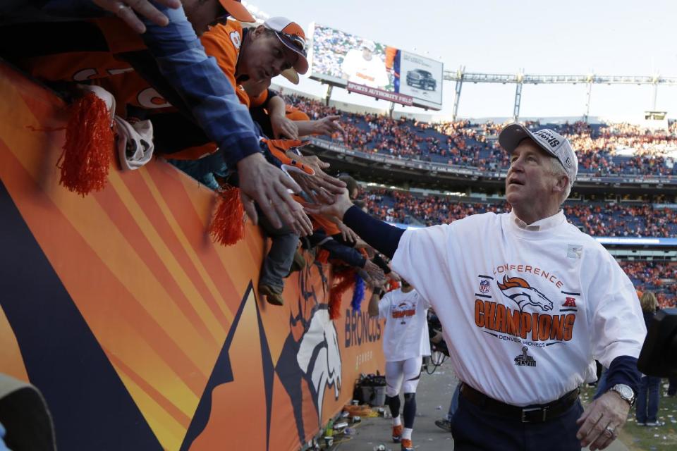 Denver Broncos head coach John Fox celebrates with fans as he leaves the field after the AFC Championship NFL playoff football game against the New England Patriots in Denver, Sunday, Jan. 19, 2014. The Broncos defeated the Patriots 26-16 to advance to the Super Bowl. (AP Photo/Julie Jacobson)