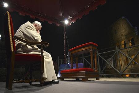 Pope Francis attends the Via Crucis (Way of the Cross) procession during Good Friday celebrations in front of the Colosseum in Rome April 18, 2014. REUTERS/Alberto Pizzoli/Pool