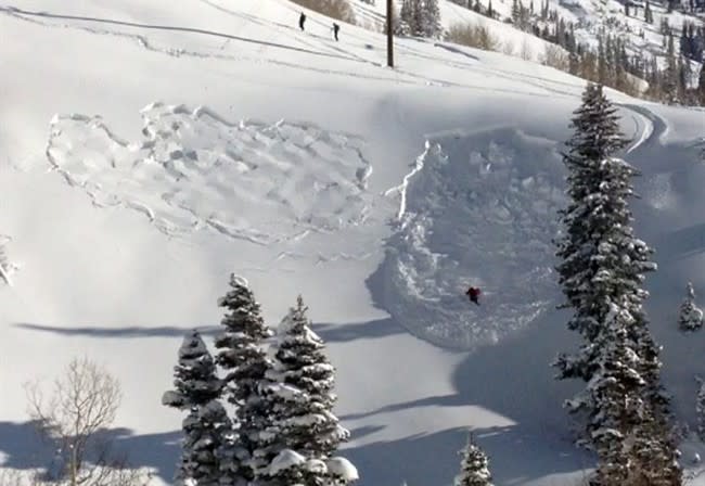 In this photo provided by Joseph Campanelli, the first in a sequence of three images, a skier triggers an avalanche as she turns into a steep ravine in Grizzly Gulch, just outside the Alta ski area east of Salt Lake City, Monday, Dec. 9, 2013. The woman survived because she deployed a special air bag and other skiers were able to quickly dig her out. It was the first time this season that a person has been caught in an avalanche in the state. Authorities say she could've been trapped longer under much deeper snow without the air bag. (AP Photo/Joseph Campanelli)
