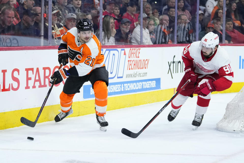 Philadelphia Flyers' Scott Laughton, left, tries to keep away from Detroit Red Wings' Jake Walman during the second period of an NHL hockey game, Sunday, March 5, 2023, in Philadelphia. (AP Photo/Matt Slocum)