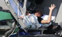 Injured Brazilian national soccer team player Neymar waits to be airlifted home from Brazil's training camp inTeresopolis, near Rio de Janeiro, July 5, 2014. REUTERS/Marcelo Regua