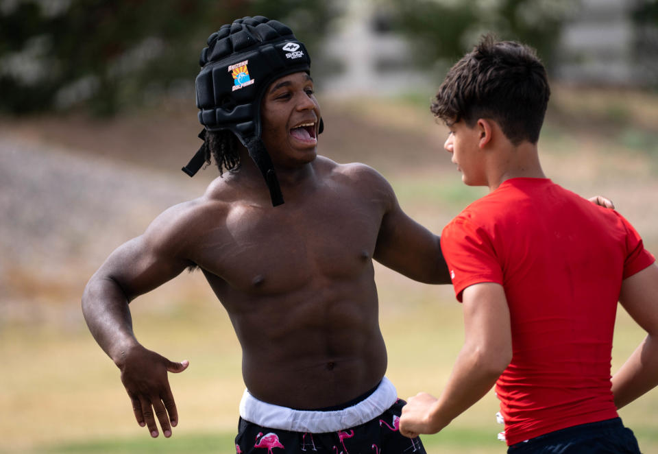 Kavaughn Clark (left, RB) greets a teammate on April 26, 2022, during spring football practice at Centennial High School, Peoria, Arizona.