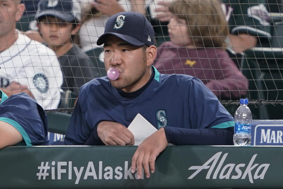 Seattle Mariners pitcher Yusei Kikuchi, who has been selected to the American League All-Star team, blows a bubble as he watches from the dugout during the Mariners' baseball game against the New York Yankees, Tuesday, July 6, 2021, in Seattle. (AP Photo/Ted S. Warren)