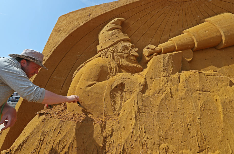 A sand carver works on a sculpture during the Sand Sculpture Festival "Dreams" in Ostend, Belgium June 18, 2019. (Photo: Yves Herman/Reuters)