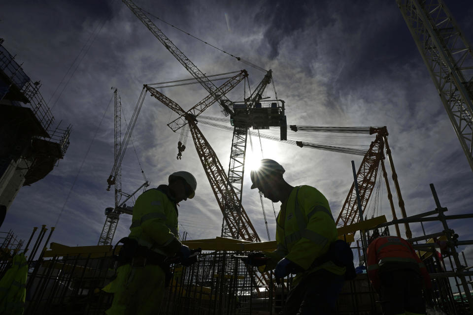 A worker works at a construction site of Hinkley Point C nuclear power station in Somerset, England, Tuesday, Oct. 11, 2022. The Hinkley Point C project is estimated to cost up to 26 billion pounds ($30 billion) and is set to be completed in 2027. (AP Photo/Kin Cheung)