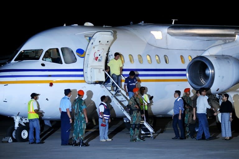 Indonesian sailors, who were taken hostage by Abu Sayyaf Islamic militants in the Philippines, get off a plane upon their arrival at Halim Perdanakusuma Airbase in Jakarta, on May 1, 2016