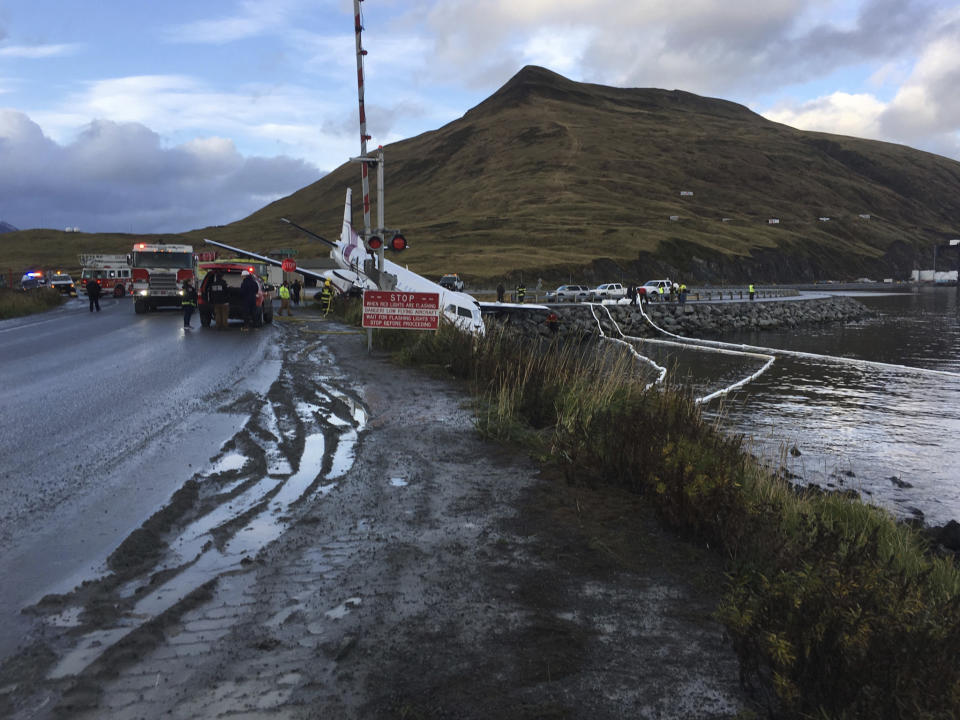 A commuter airplane has crashed near the airport in a small Alaska community on the Bering Sea, Thursday, Oct. 17, 2019, in Unalaska, Alaska. Freelance photographer Jim Paulin says the crash at the Unalaska airport occurred Thursday after 5 p.m. Paulin says the Peninsula Airways flight from Anchorage to Dutch Harbor landed about 500 feet (152 meters) beyond the airport near the water. (Jim Paulin via AP)