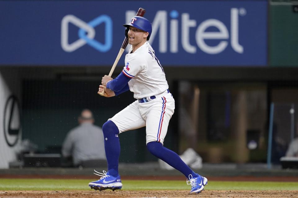 Texas Rangers' Brad Miller follows through on a run-scoring single in the eighth inning of a baseball game against the Houston Astros, Monday, June 13, 2022, in Arlington, Texas. Ezequiel Duran scored on the hit. (AP Photo/Tony Gutierrez)