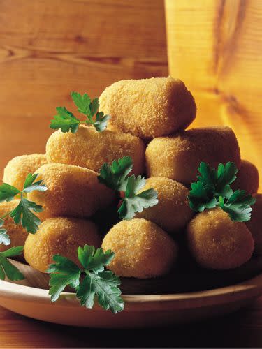 <p>Form cold mashed potatoes into little balls, dip in beaten egg, coat in bread crumbs, and sauté or deep-fry. You can also mix in crabmeat or salmon.</p>