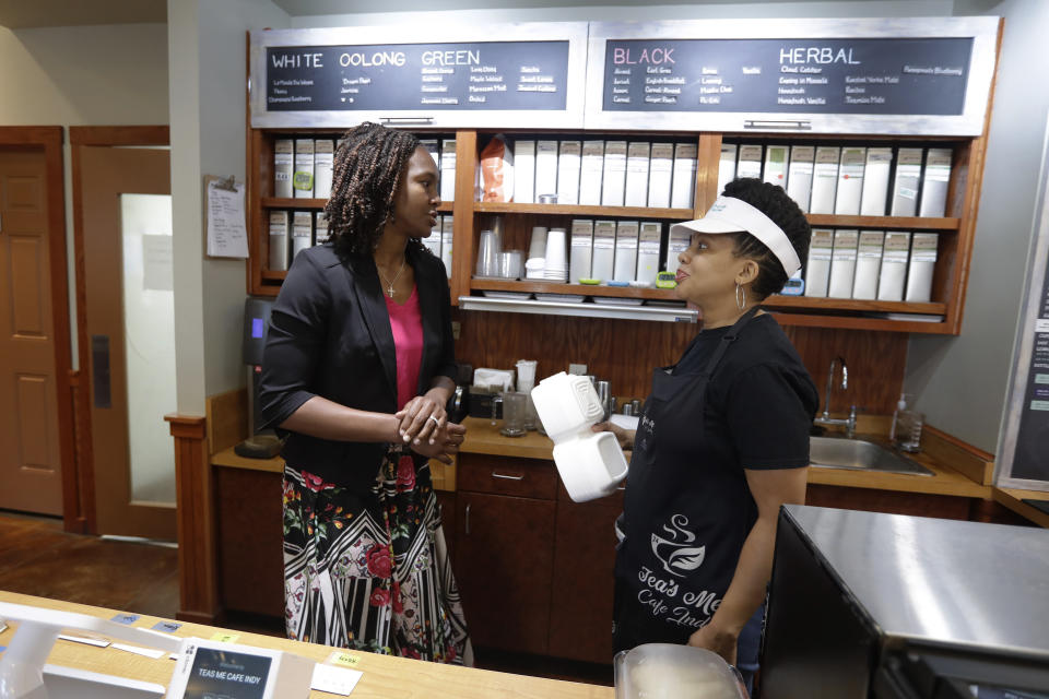 Tamika Catchings, left, talks with Joi DeFrantz at Tea's Me Cafe, Wednesday, June 26, 2019, in Indianapolis. (AP Photo/Darron Cummings)