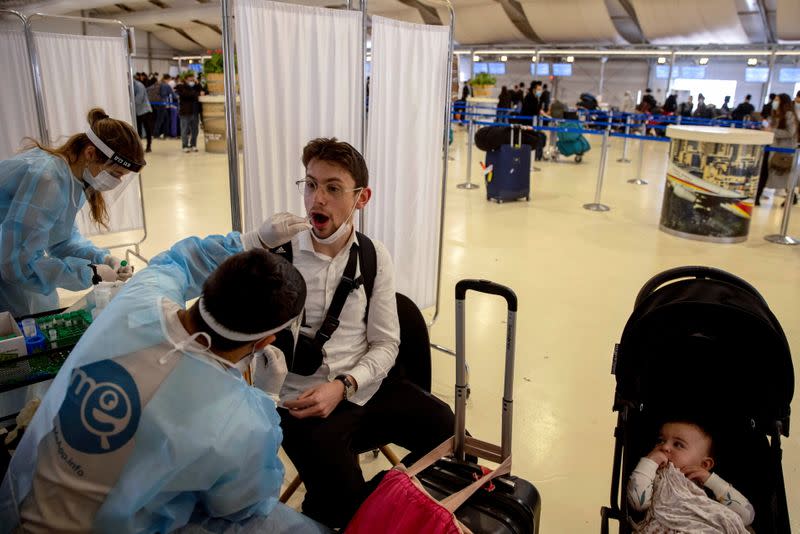 People returning from overseas arrive at Ben Gurion International Airport