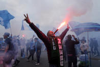 Napoli fans celebrates on the street after their team scored the first goal during the Serie A soccer match between Napoli and Salernitana at the Diego Armando Maradona stadium, in Naples, Italy, Sunday, April 30, 2023. (AP Photo/Gregorio Borgia)