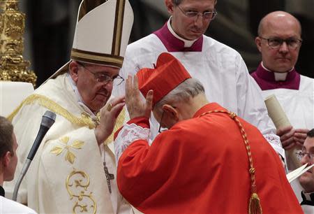 Pope Francis blesses newly elected cardinal Lorenzo Baldisseri of Italy during a consistory ceremony in Saint Peter's Basilica at the Vatican February 22, 2014. REUTERS/Max Rossi