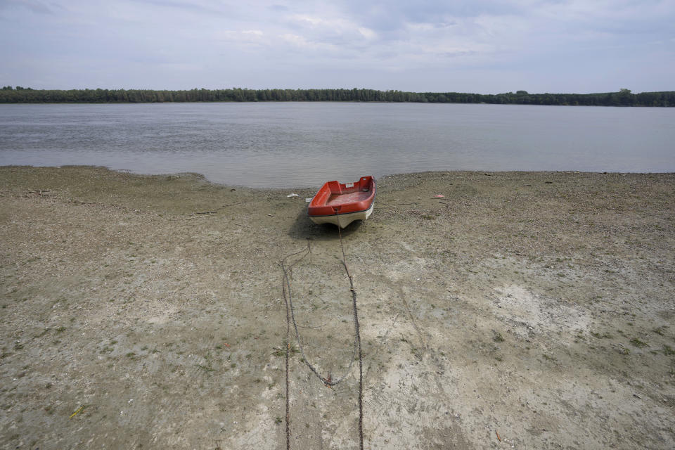 FILE - A boat laying on a dry bank of river Danube after a long time of drought near the village of Cortanovci, 50 kilometers north-west of Belgrade, Serbia, Tuesday, Aug. 9, 2022. (AP Photo/Darko Vojinovic, File)