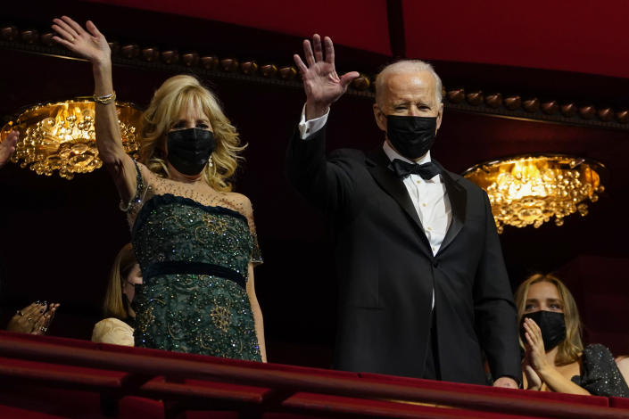 President Joe Biden and first lady Jill Biden wave as they arrive at the 44th Kennedy Center Honors at the John F. Kennedy Center for the Performing Arts in Washington, Sunday, Dec. 5, 2021. The 2021 Kennedy Center honorees include Motown Records creator Berry Gordy, "Saturday Night Live" mastermind Lorne Michaels, actress-singer Bette Midler, opera singer Justino Diaz and folk music legend Joni Mitchell. (AP Photo/Carolyn Kaster)