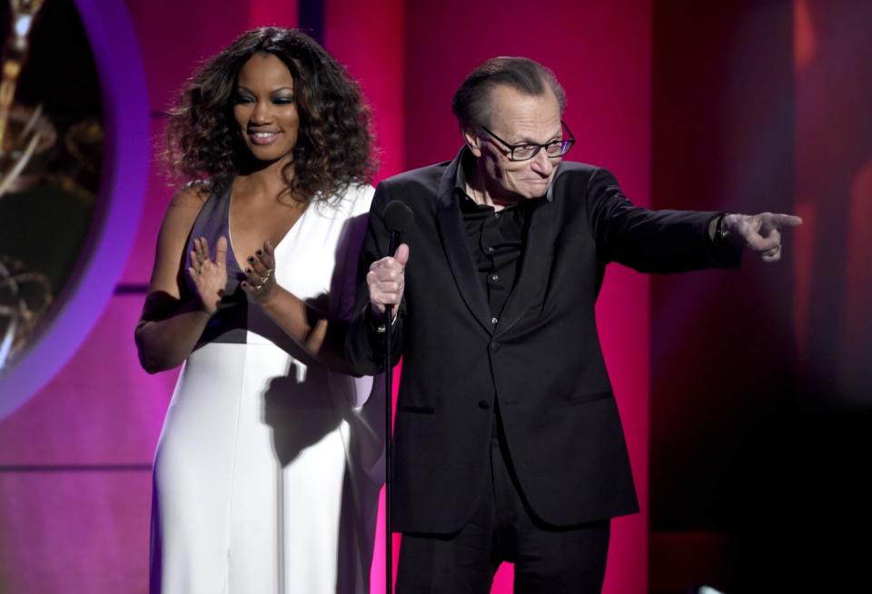 Larry King on stage with Garcelle Beauvais at the Daytime Emmy Awards at the Pasadena Civic Center on April 30, 2017.