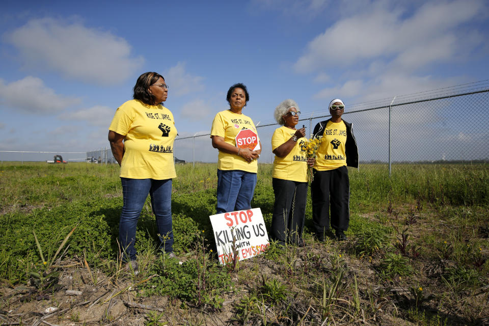 FILE - Myrtle Felton, from left, Sharon Lavigne, Gail LeBoeuf and Rita Cooper, members of RISE St. James, conduct a live stream video on property owned by Formosa on March 11, 2020, in St. James Parish, La. A complaint says the Louisiana Department of Environmental Quality is ignoring the threat that new industrial facilities like Formosa's pose to already polluted areas. (AP Photo/Gerald Herbert, File)