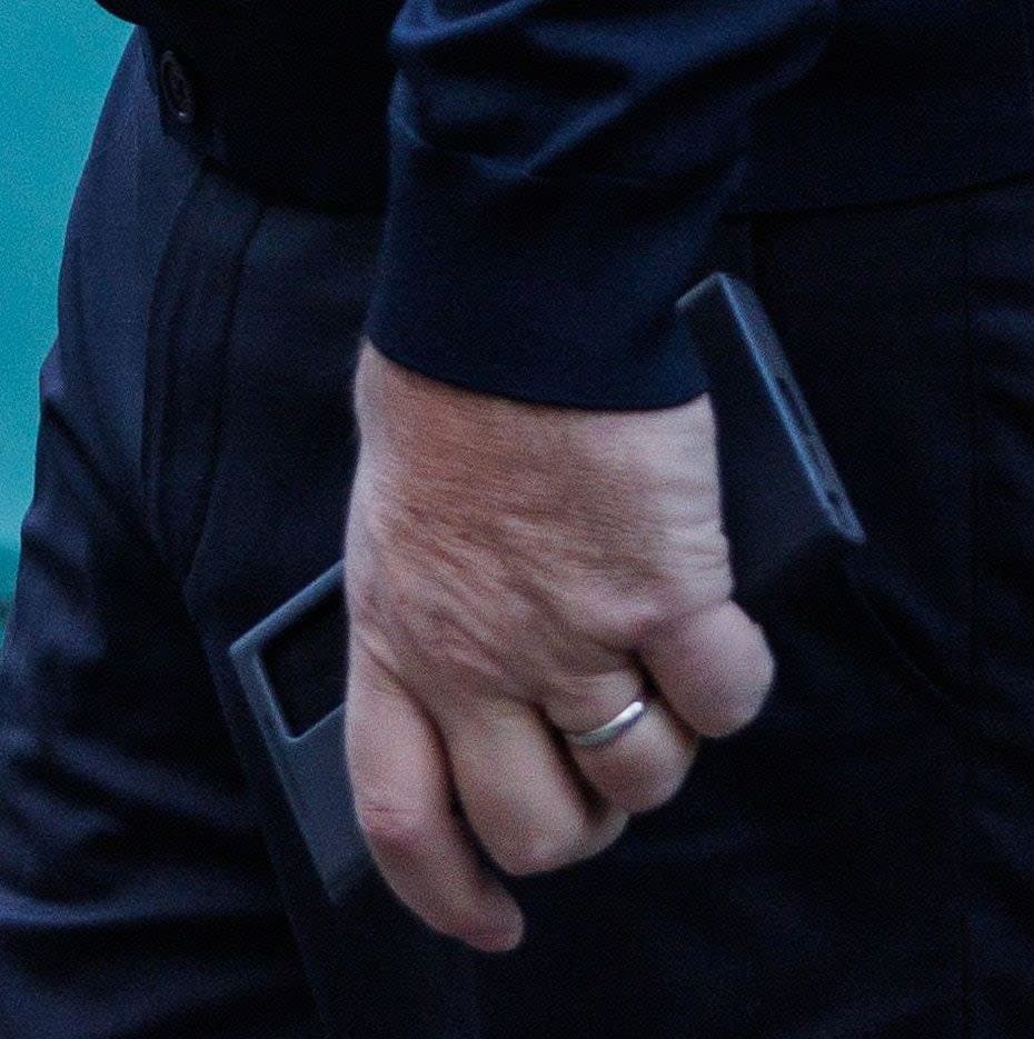 Huw Edwards, seen holding his mobile phone outside Westminster magistrates' court