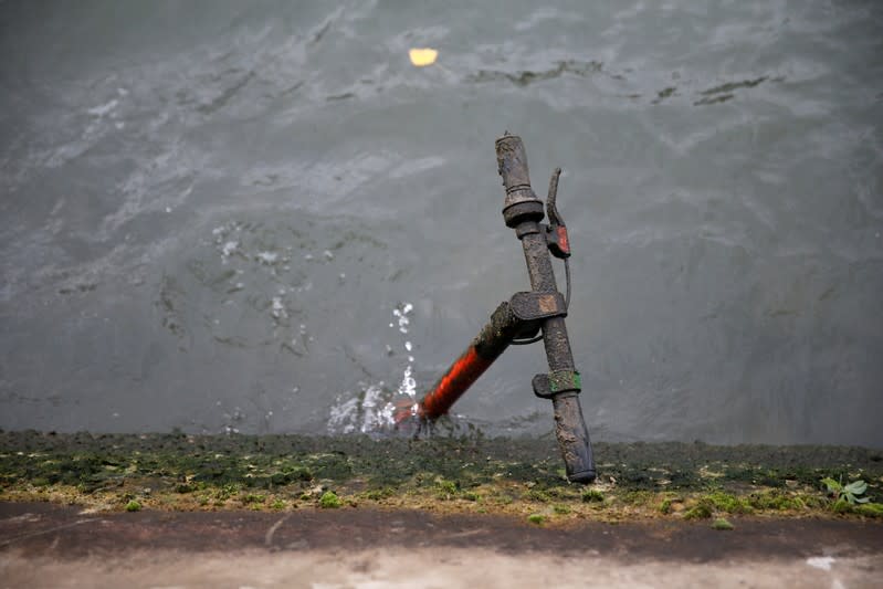 An abandoned electric scooter is seen in the River Seine in Paris