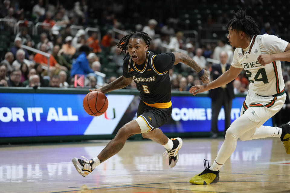 La Salle guard Khalil Brantley (5) drives past Miami guard Nijel Pack (24) during the first half of an NCAA college basketball game, Saturday, Dec. 16, 2023, in Coral Gables, Fla. (AP Photo/Rebecca Blackwell)