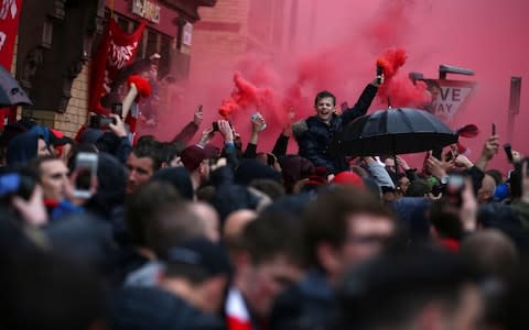 Red flares are lit outside the stadium before the Champions League semifinal - Credit: AP