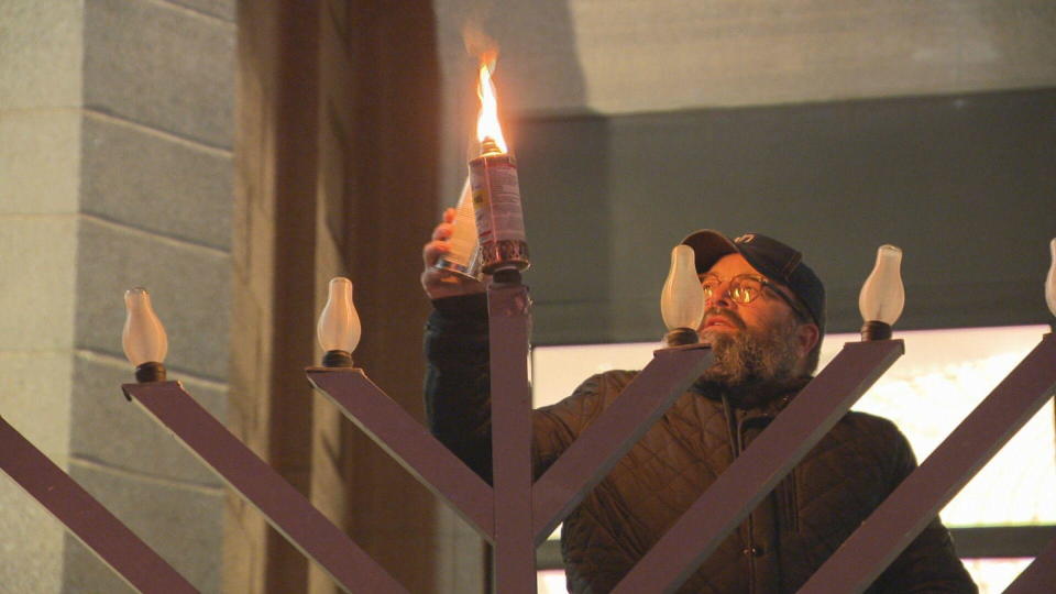 Rabbi Bill Hamilton from Congregation Kehillath Israel lit the menorah on Harvard Street in Brookline to mark Hanukkah's first night. / Credit: CBS Boston