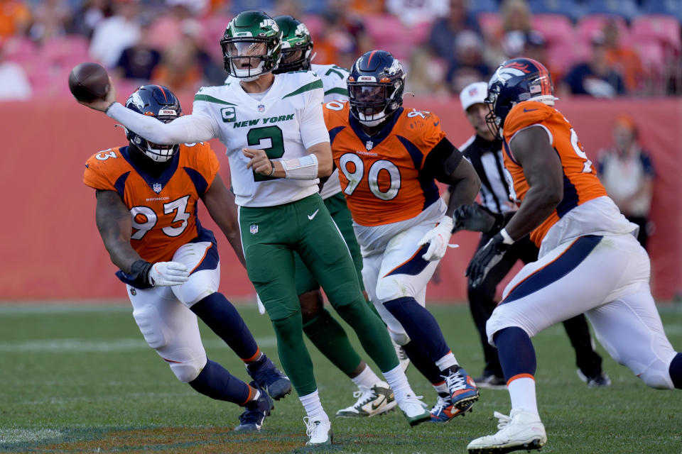 New York Jets quarterback Zach Wilson (2) throws under pressure against the Denver Broncos during the second half of an NFL football game, Sunday, Sept. 26, 2021, in Denver. The Broncos won 26-0. (AP Photo/David Zalubowski)