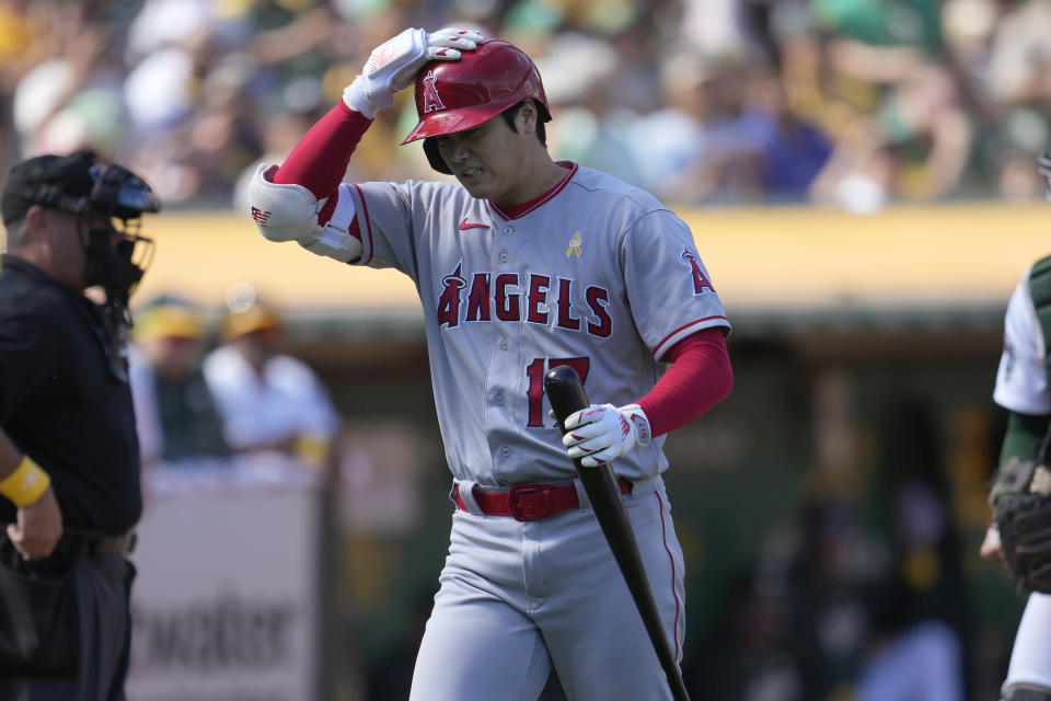 Los Angeles Angels' Shohei Ohtani walks to the dugout after striking out against the Oakland Athletics during the seventh inning of a baseball game in Oakland, Calif., Sunday, Sept. 3, 2023. (AP Photo/Jeff Chiu)