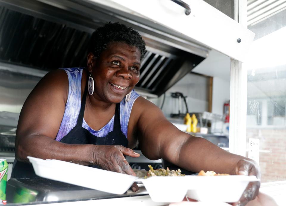 Yvonne Lawson, known to community members as Granny, serves meals from her food truck during a Brown County Reach, Immunizations, System Change for Equity (RISE) event at We All Rise in Green Bay.