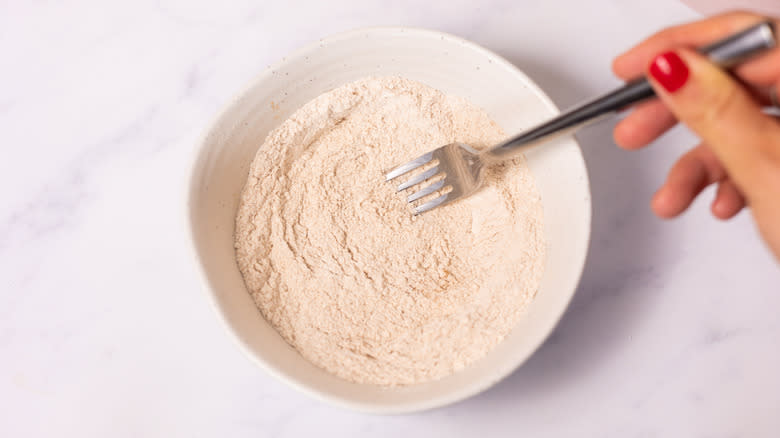 dry flour mixture in bowl with fork