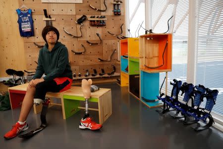 Chie Yamashita wears prosthetic "blade" during an opening ceremony of a special "library" that lets people borrow and try out prosthetic "blades" for runners, in Tokyo, Japan, October 15, 2017. Picture taken October 15, 2017. REUTERS/Kim Kyung-Hoon