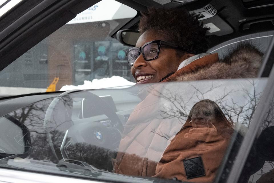 Sheri Neale, from Near East Side, sits in her car while speaking with Brandis Mason after donating goods during a gift drive Saturday to benefit Kyair and Kason Thomas. The twins were recently found after being abducted. It’s reflective of this nation, Neale said, that “a mother is having to do Door Dash delivery… with her twins.”