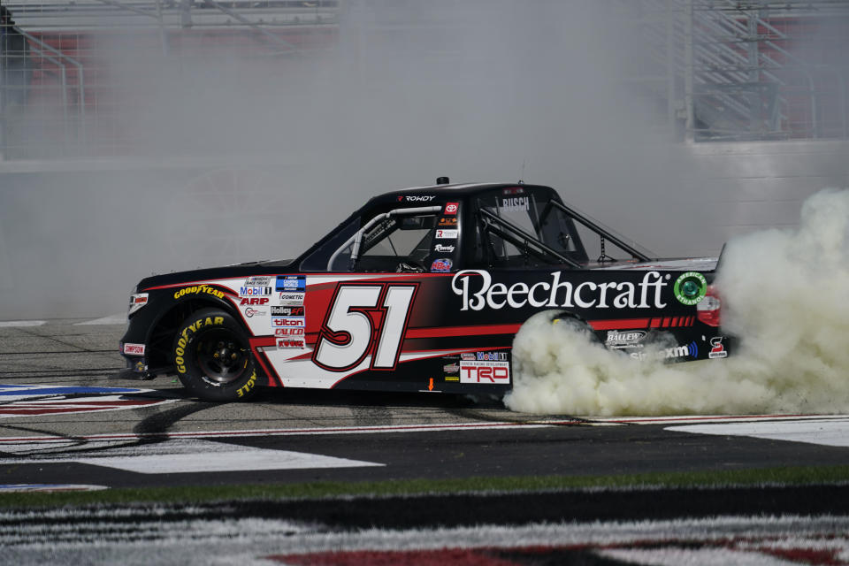 NASCAR driver Kyle Busch celebrates after he wins a NASCAR Camping World Truck Series race at Atlanta Motor Speedway on Saturday, March 20, 2021, in Hampton, Ga. (AP Photo/Brynn Anderson)