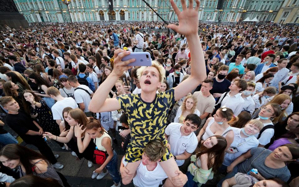 Students ditch Covid rules to gather for the Scarlet Sails festivities marking school graduation at the Palace Square in St Petersburg, Russia - Dmitri Lovetsky/AP