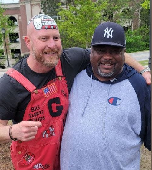 Trent 'Big Dawg' Woods, left, poses for a picture with Keith Lane of Athens during a sporting event.