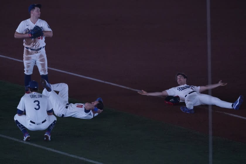 From top left to right, the Dodgers' Joc Pederson, Chris Taylor, AJ Pollock and Kiké Hernández wait out a power delay.