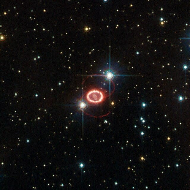 Supernova 1987-A photographed against a starry space background.
