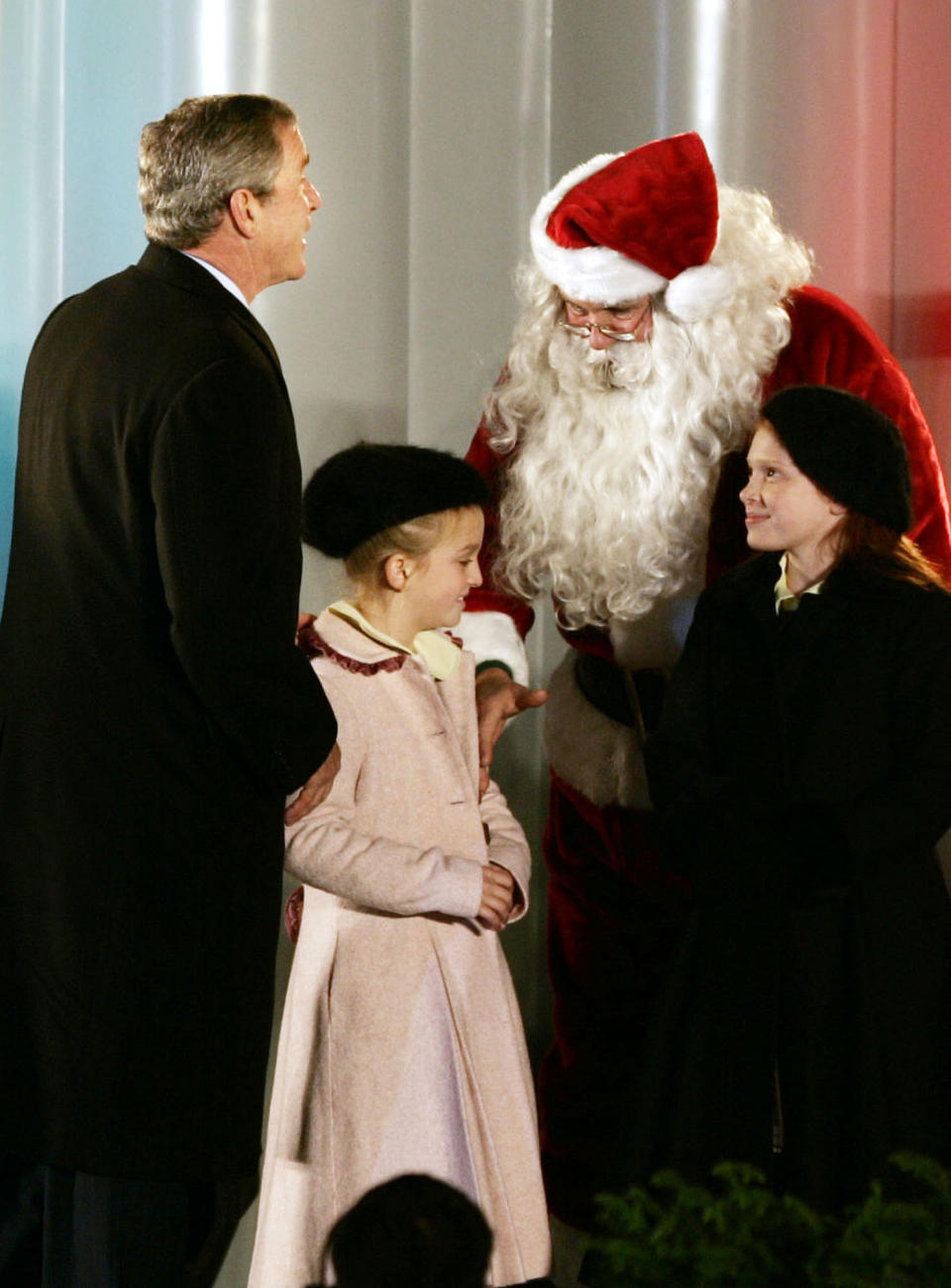 President Bush greets Santa Claus, played by Willard Scott, with children Clara Pitts, second left, and Nicole Mastracchio at the conclusion of the National Christmas Tree lighting ceremony in The Ellipse in front of the White House in Washington Thursday, Dec. 2, 2004. (AP Photo/Gerald Herbert)