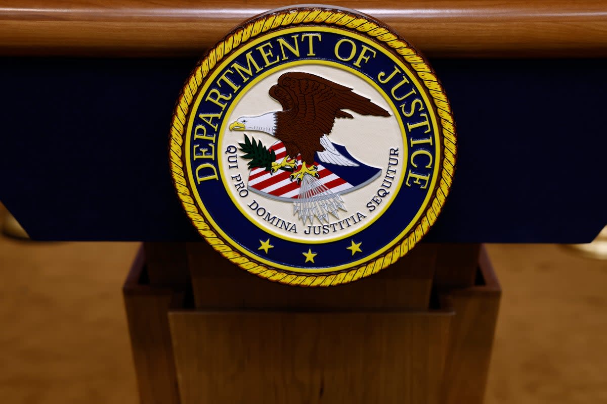 A seal for the Department of Justice is seen on a podium ahead of a news conference with US Attorney General Merrick Garland at the Department of Justice Building on 21 March 2024 in Washington, DC (Getty Images)