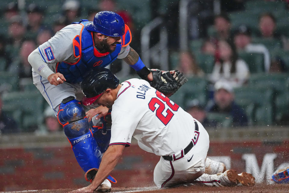 Atlanta Braves' Matt Olson (28) is forced out at home by New York Mets catcher Omar Narváez (2) on an Orlando Arcia ground ball in the third inning of a baseball game Tuesday, April 9, 2024, in Atlanta. (AP Photo/John Bazemore)