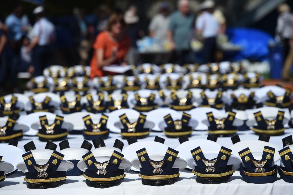 The new hats and shoulder bars for the graduates sit on a table before the start of the U.S. Coast Guard Academy's 141st Commencement Exercises, May 18, 2022 in New London, Conn.