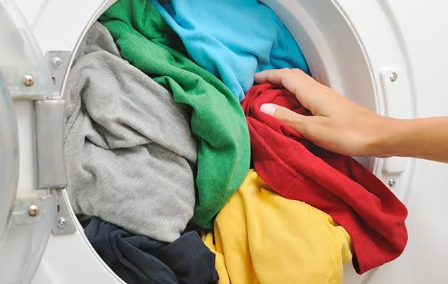 Keep your laundry clean by using big IKEA bags to store your clothes. Photo: Getty